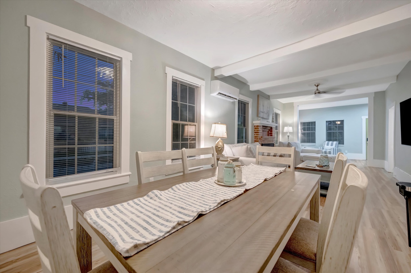 Gather around the welcoming dining table for meals and memories, with an airy open-concept layout that flows seamlessly into the living space—perfect for togetherness and relaxation.