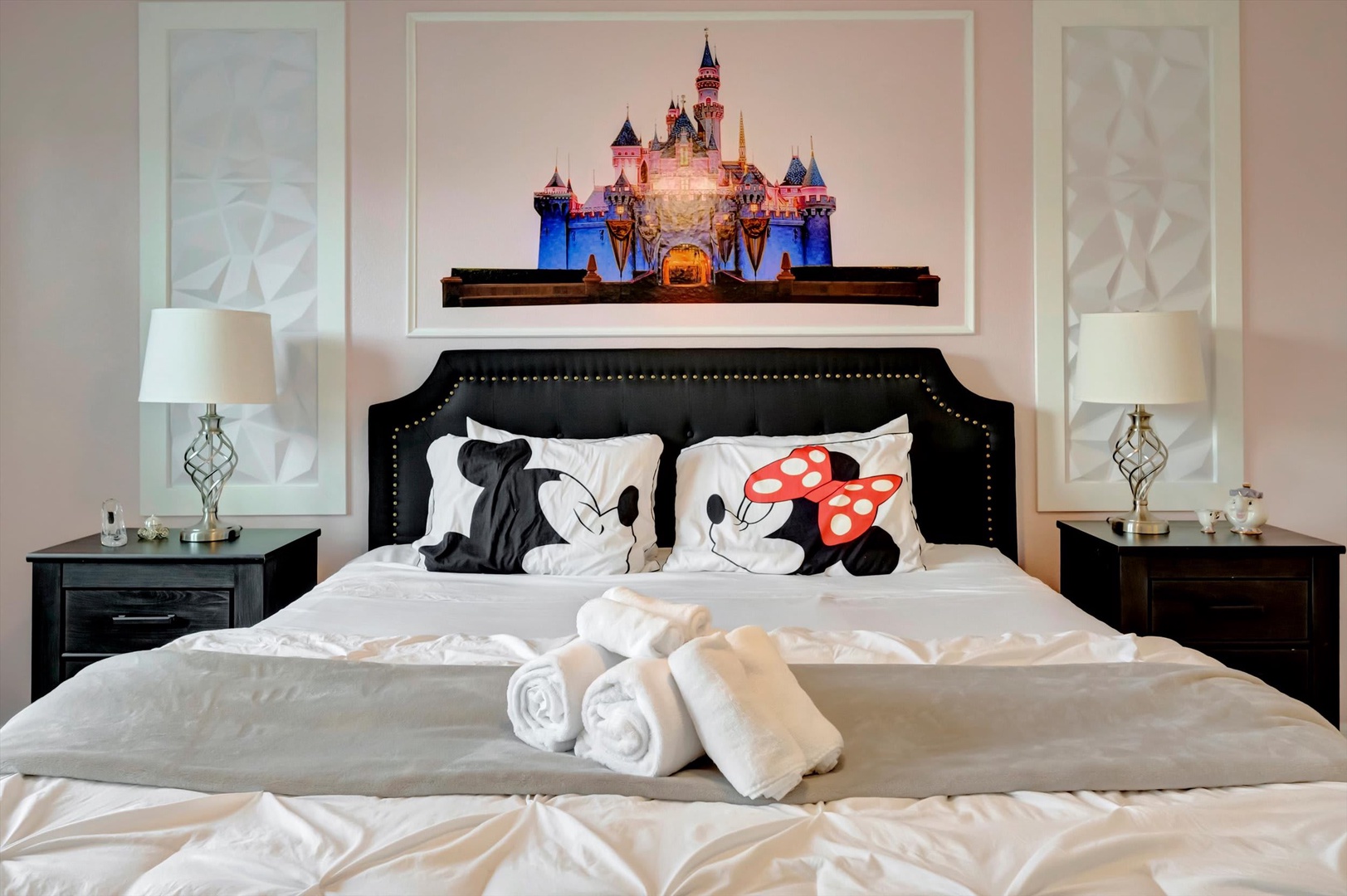 Relax in style with crisp white linens, plush rolled towels, and charming themed pillows. Your cozy retreat awaits with elegant bedside lamps and tasteful décor.