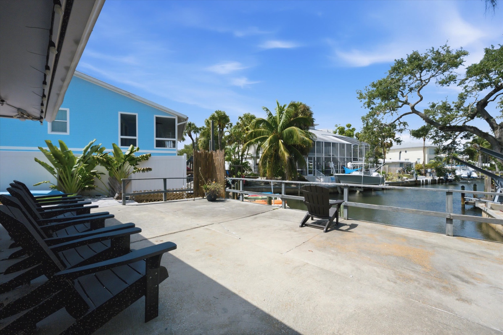 Relax on your private waterfront patio, where lounge chairs face the peaceful canal and tropical palms sway overhead—perfect for morning coffee or sunset drinks.