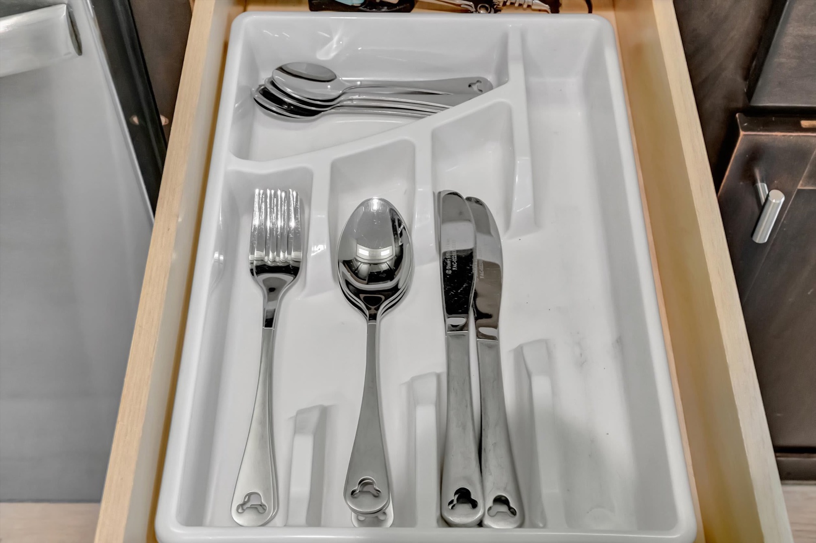 An organized utensil drawer holds essentials for your home-cooked meals, with sleek silverware neatly arranged in a clean white tray.