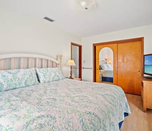 Rest well in this light-filled bedroom with its comfortable bed, warm wood accents, and soft coastal linens that set a serene, beachy tone for your stay.