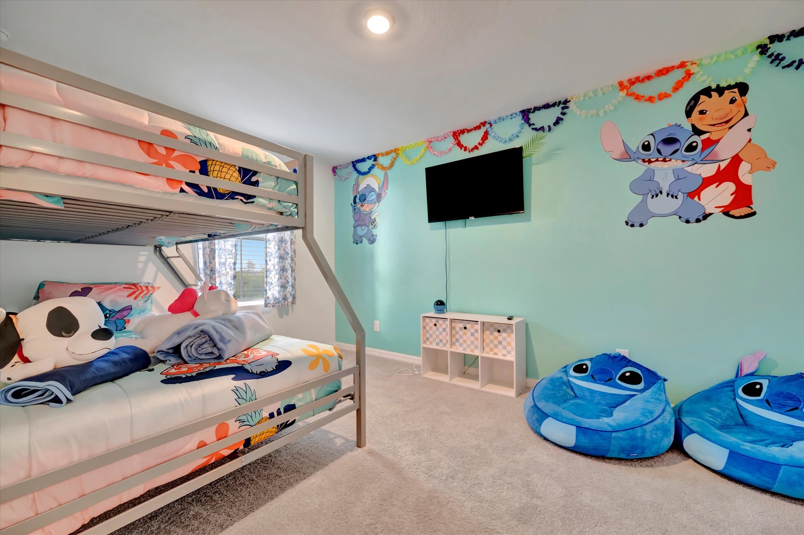 Your kids will love this cheerful themed bedroom with colorful bunk beds, playful floor cushions, and plenty of space to unwind after a day of adventure.