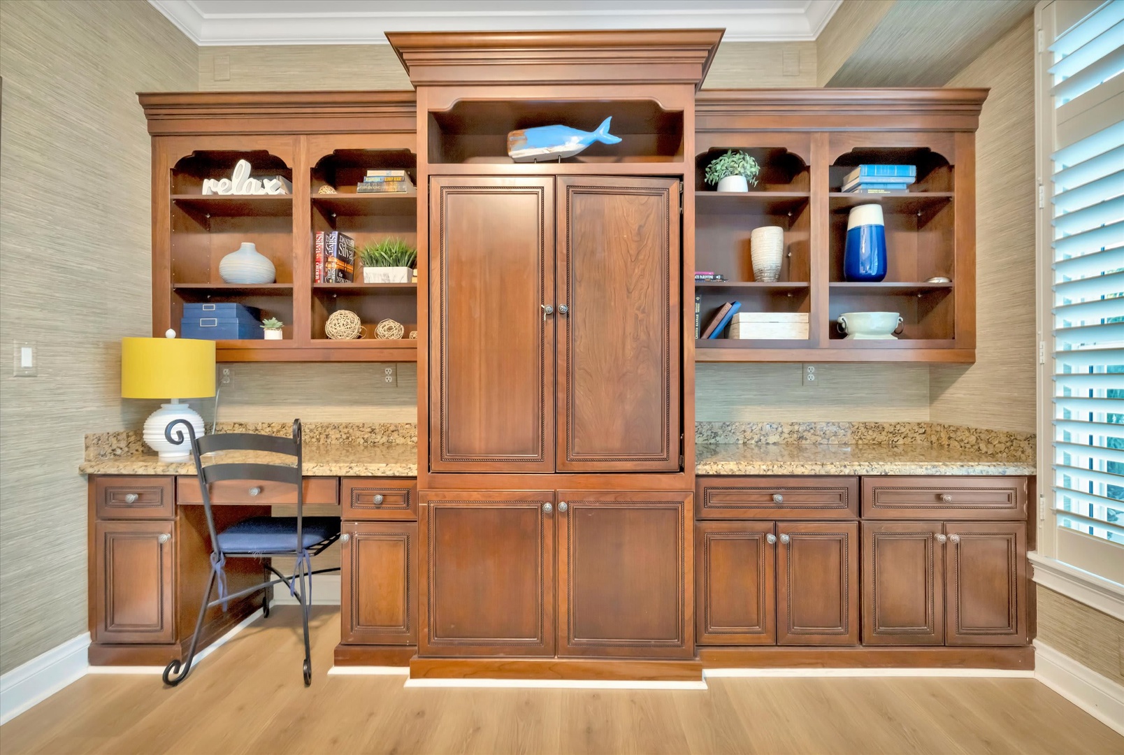 Your home away from home features a beautifully crafted built-in workspace with rich wood cabinetry, plenty of storage, and a dedicated desk area—perfect for catching up on work or planning your next adventure.