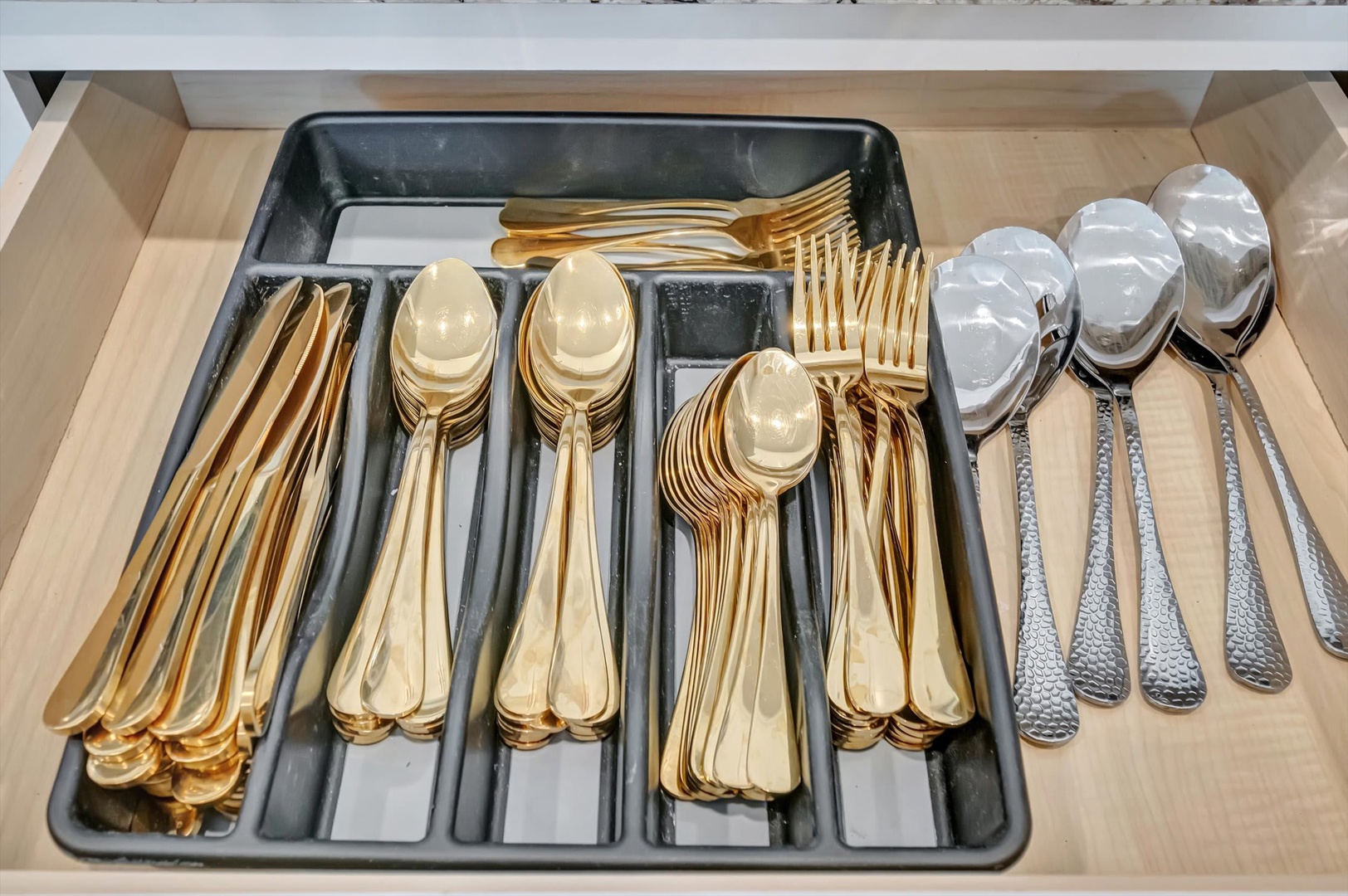 Your kitchen comes fully equipped with gleaming gold and silver flatware, neatly organized and ready for you to prepare and enjoy every meal in style.