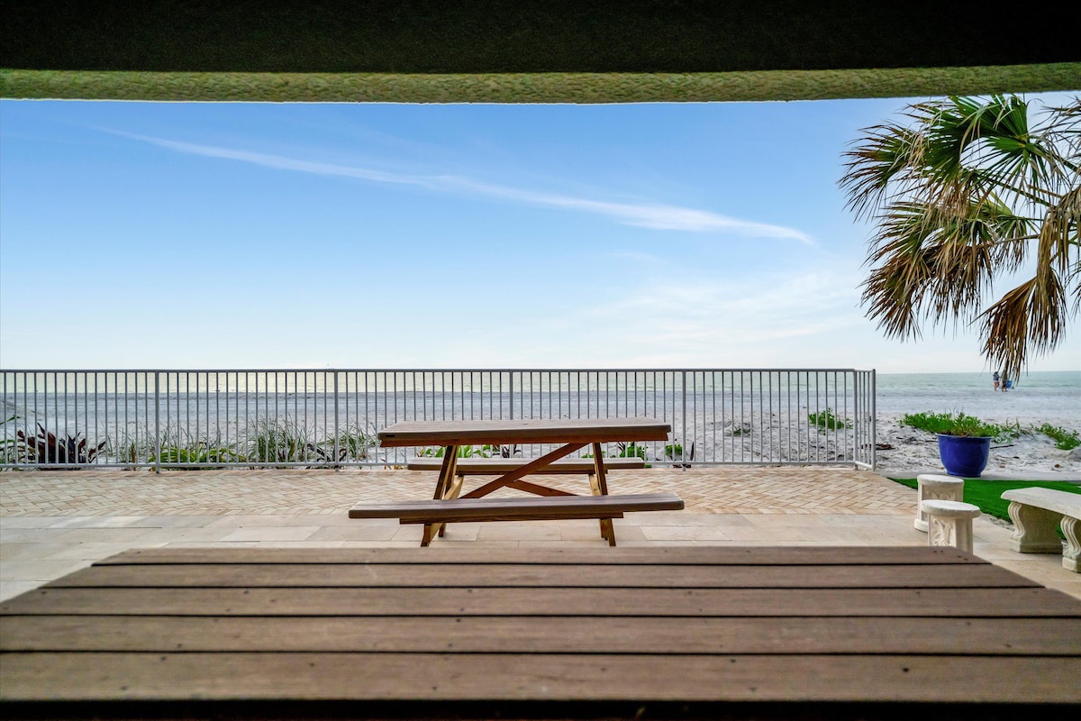 Picture your morning coffee at this beachfront picnic table, with palm trees swaying overhead and the ocean stretching endlessly before you—pure coastal serenity at your fingertips.