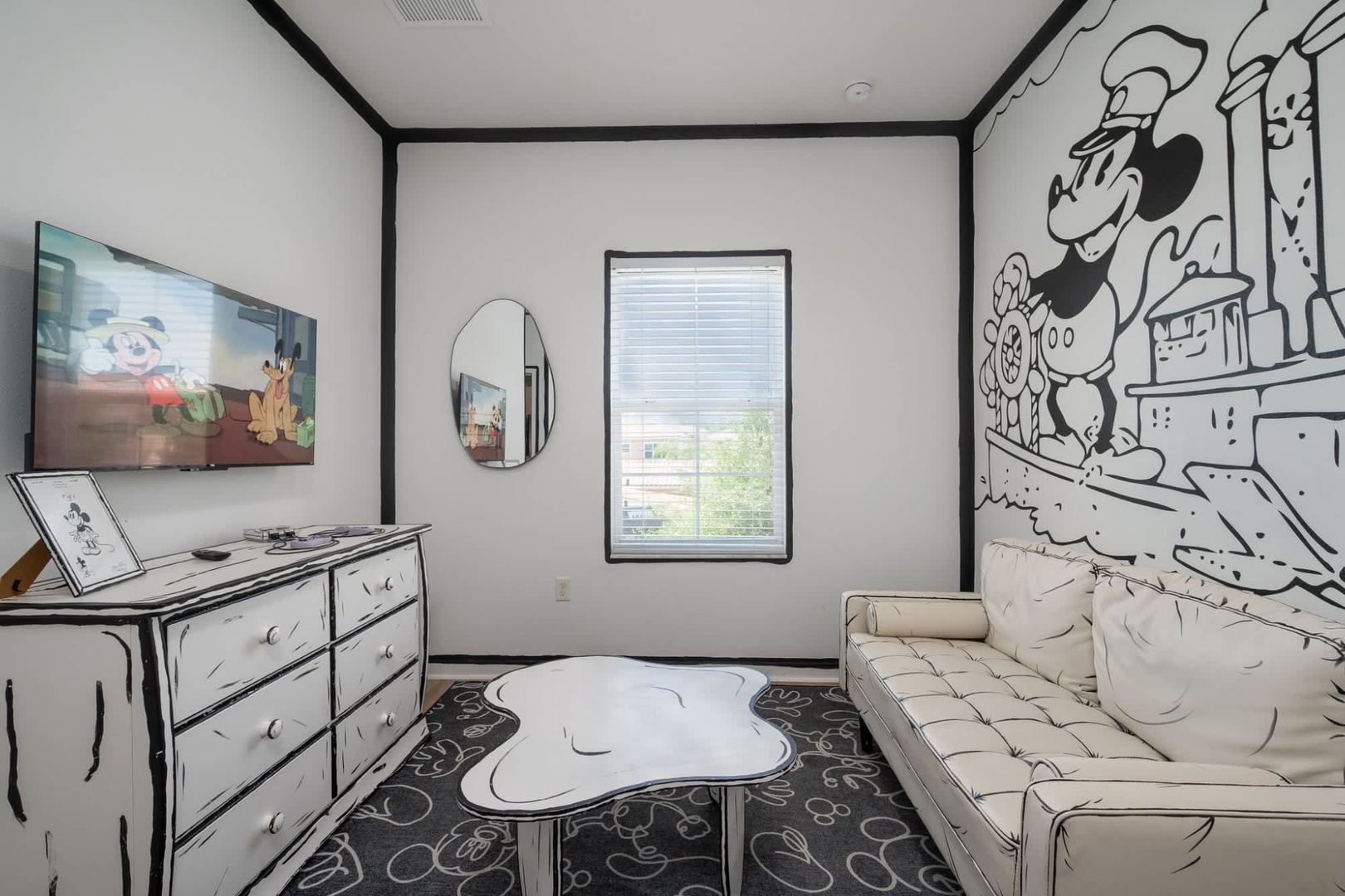 Step into your own cartoon wonderland! This whimsical room features hand-drawn murals and playful details that bring classic animation to life around you.