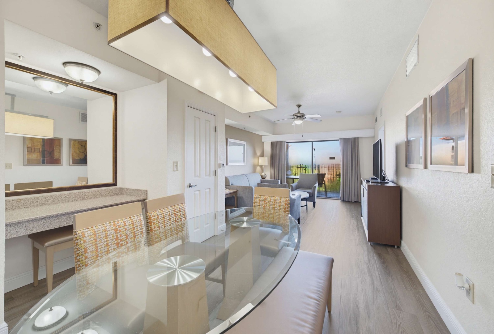 Step into your bright, open living space where natural light floods through floor-to-ceiling windows. Your dining area flows seamlessly into a relaxed lounge, and beyond, your private balcony awaits with serene outdoor views.