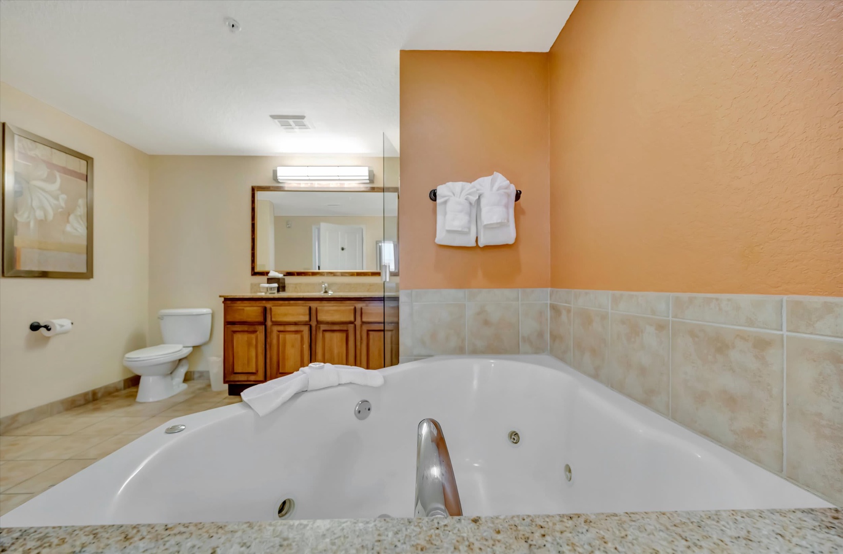 Sink into your private jetted tub after a day of exploring. Fresh towels await, and warm peach tones create a soothing retreat just for you.