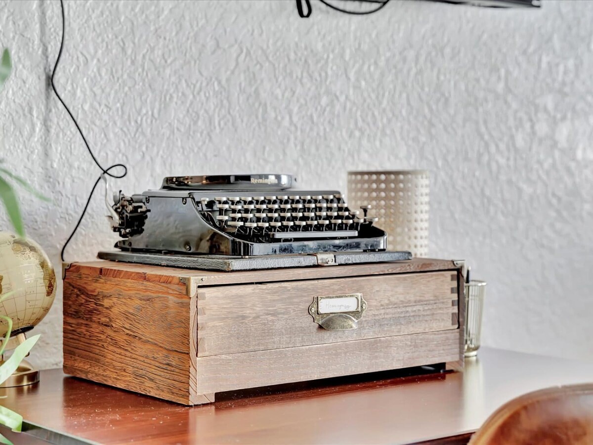A vintage typewriter adds nostalgic charm to your workspace, inviting you to slow down and savor creative moments during your stay.