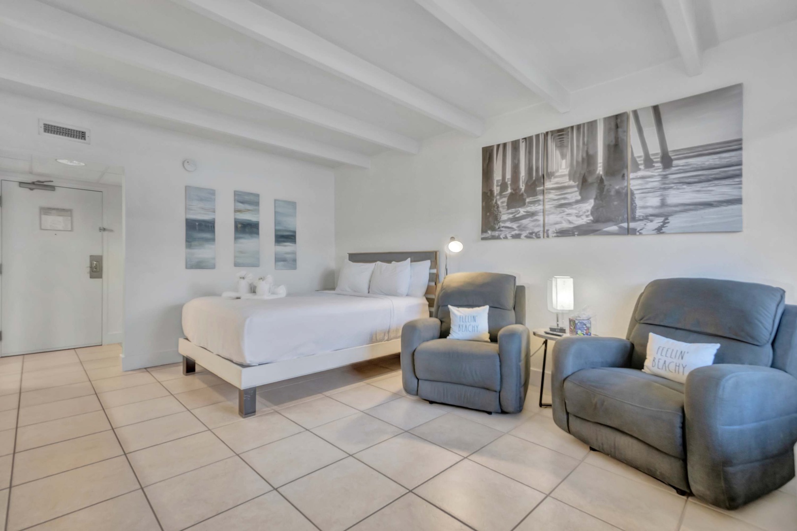 Unwind in your bright, beachside retreat with a plush bed, comfortable recliners, and coastal décor that brings the ocean right to your doorstep.