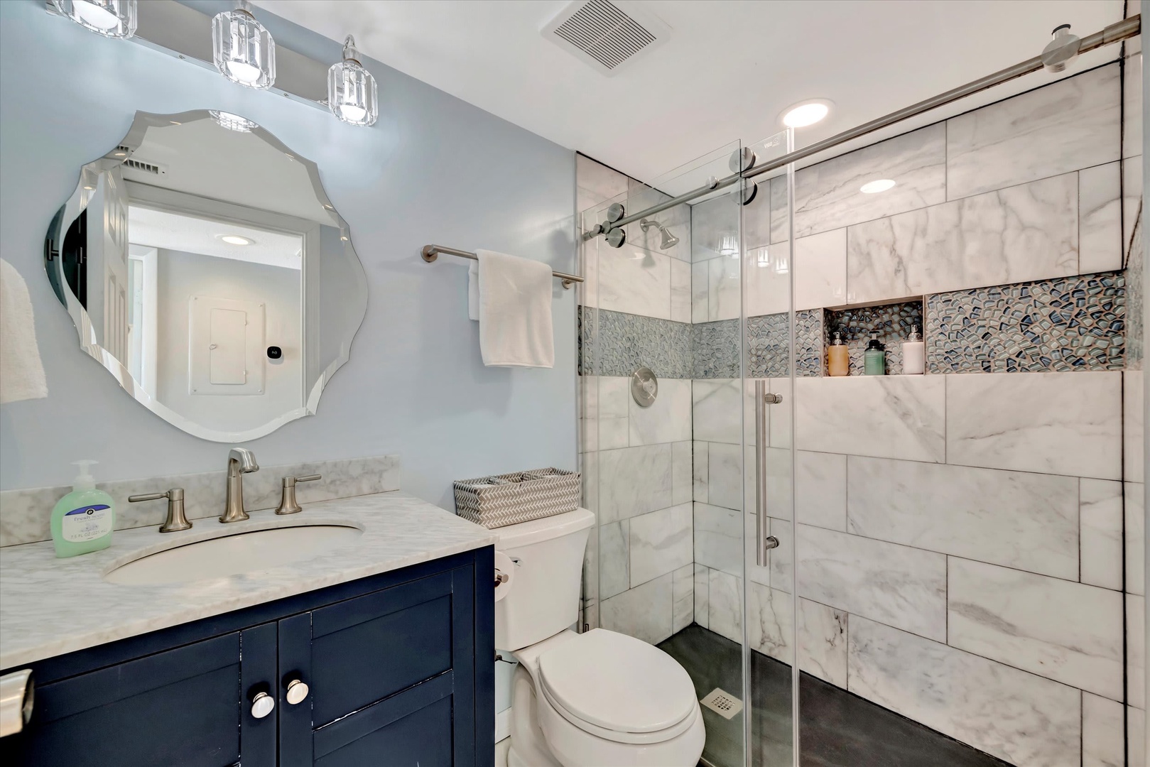 Refresh in your elegantly tiled bathroom with marble finishes, a spacious walk-in shower, and soft lighting—your private spa retreat awaits.