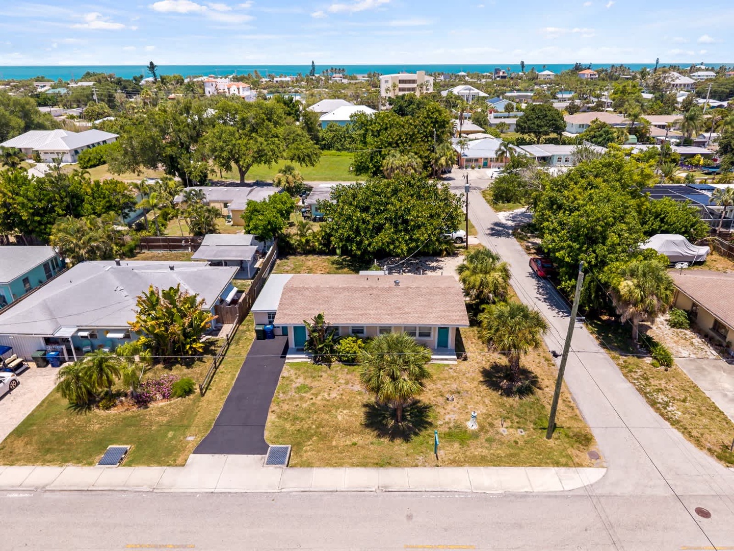 Coastal property nestled in a charming residential neighborhood, just moments from pristine turquoise waters and surrounded by lush tropical landscaping.