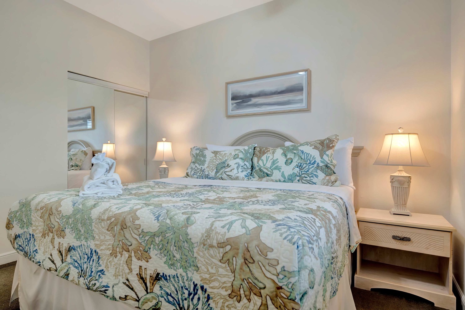 Soft coastal hues and seashell-inspired linens wrap you in comfort, while gentle bedside lighting sets a peaceful retreat at the end of your day.
