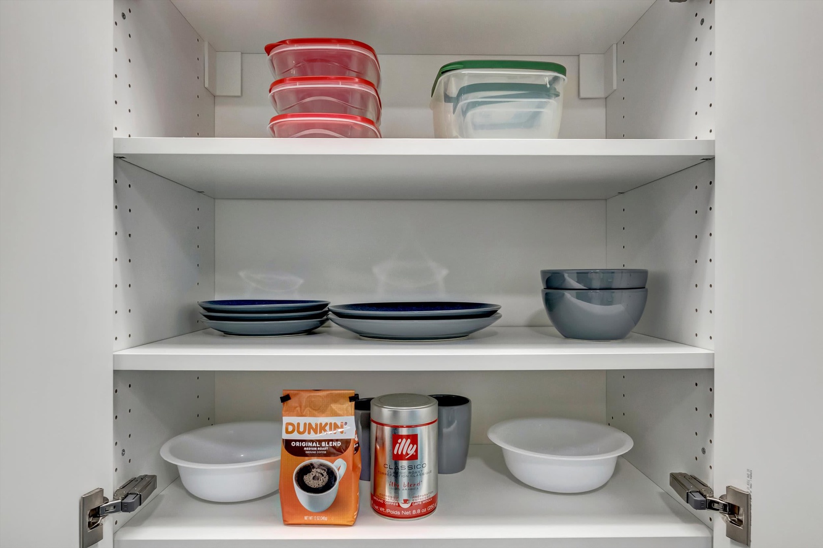 Pantry essentials and your own dishware wait inside this open cupboard, complete with coffee supplies and organized storage containers to keep you comfortable throughout your stay.