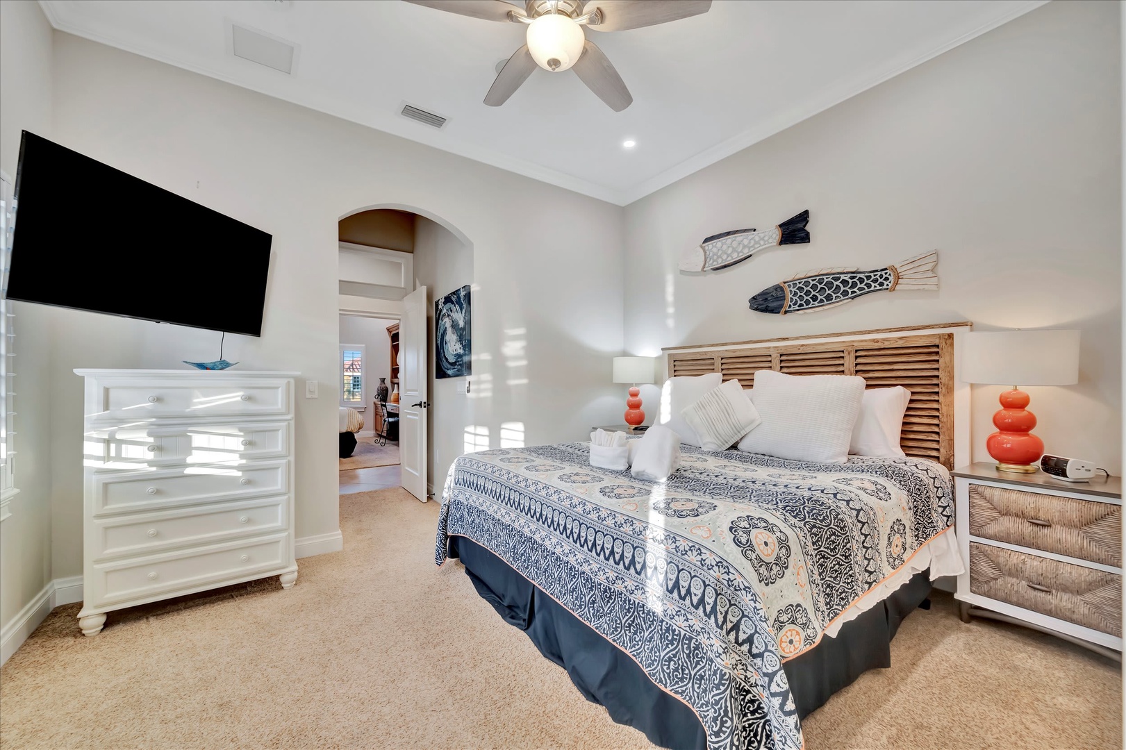 Sink into coastal comfort in your serene bedroom, complete with charming nautical touches and a ceiling fan to keep the breeze flowing.