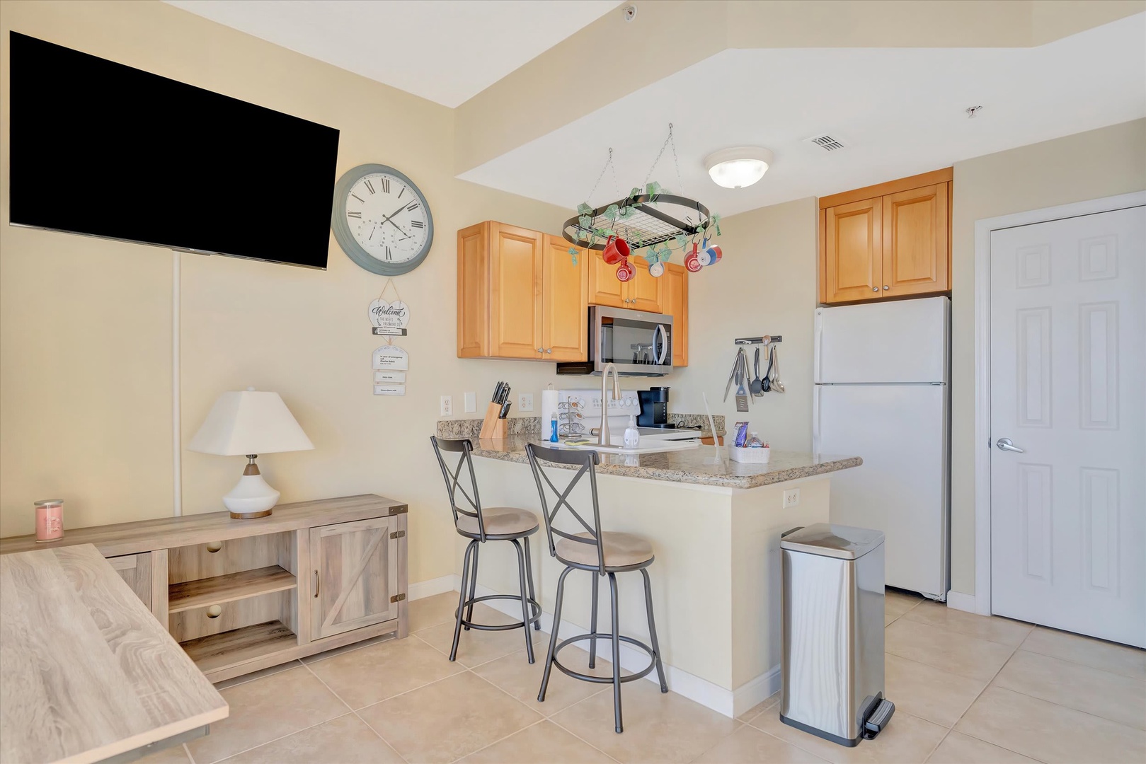 Your open kitchen features granite counters and a breakfast bar where you can sip morning coffee before heading out to explore. Everything you need is here, welcoming and ready for easy vacation living.