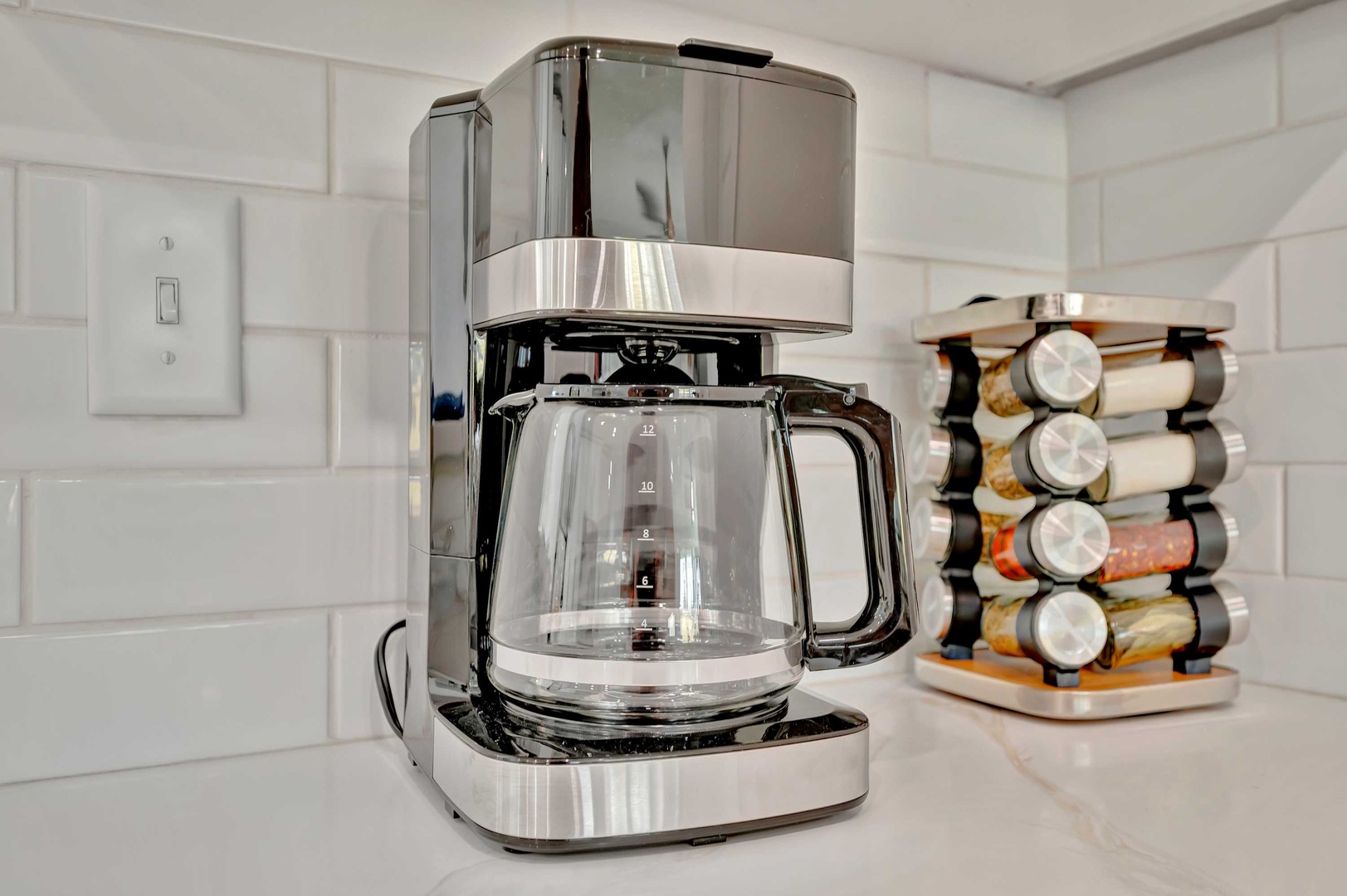 Start your mornings right with a sleek coffee maker ready for your first cup, plus a stylish spice rack to inspire home-cooked meals during your stay.