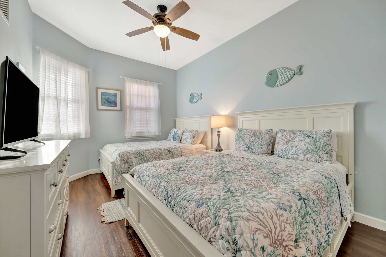Drift off to sleep in your coastal-themed bedroom with two plush beds, soft linens, and a gentle ceiling fan keeping you comfortable all night.