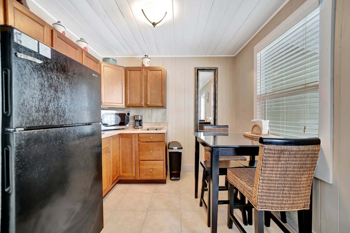 Your private kitchen blends warm wood tones with modern appliances, while the cozy dining nook invites you to savor morning coffee and plan your day's adventures.