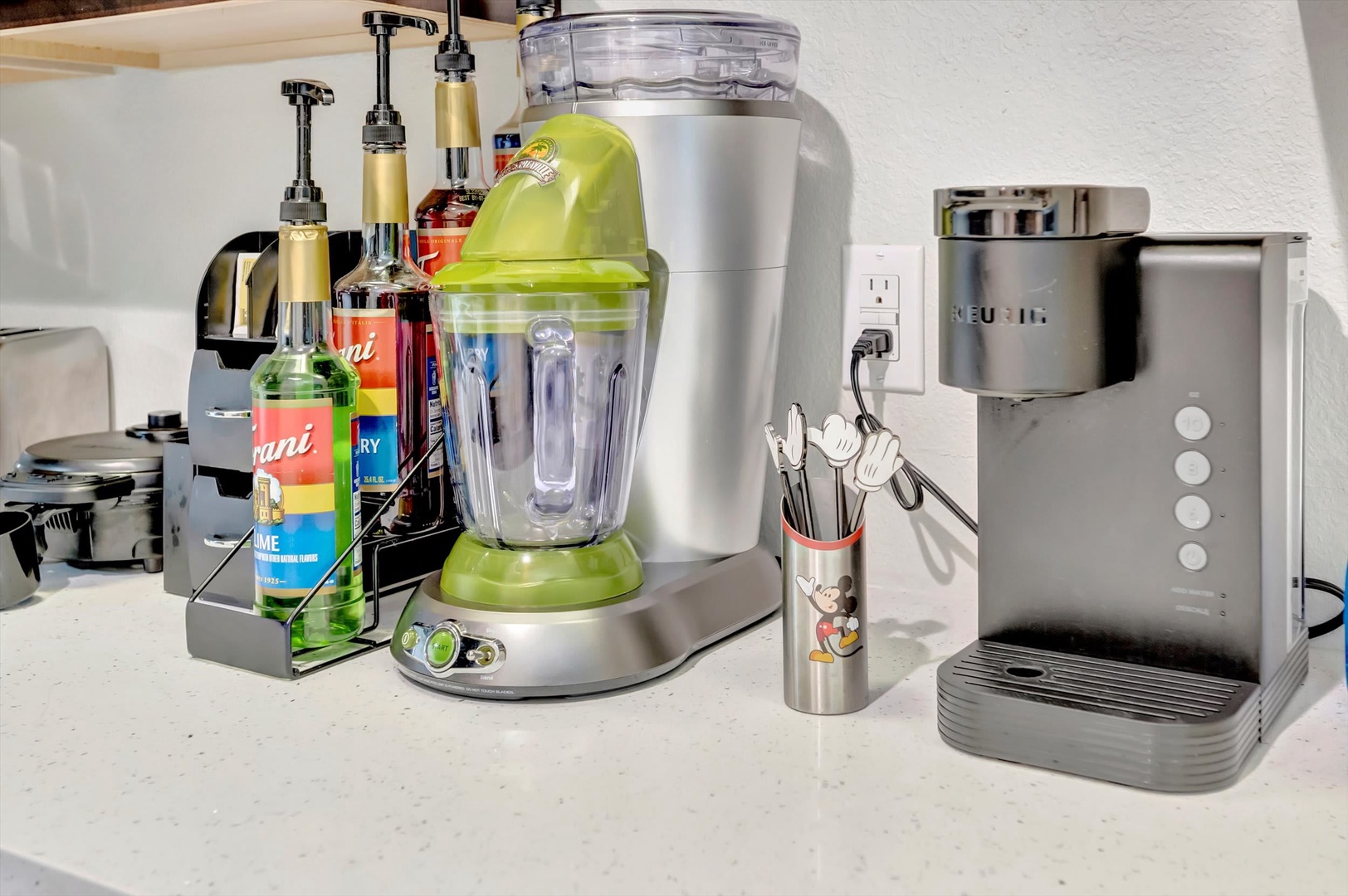 Blend your morning smoothie or craft cocktails at your own espresso station—this well-equipped kitchen counter has everything you need for drinks and treats.