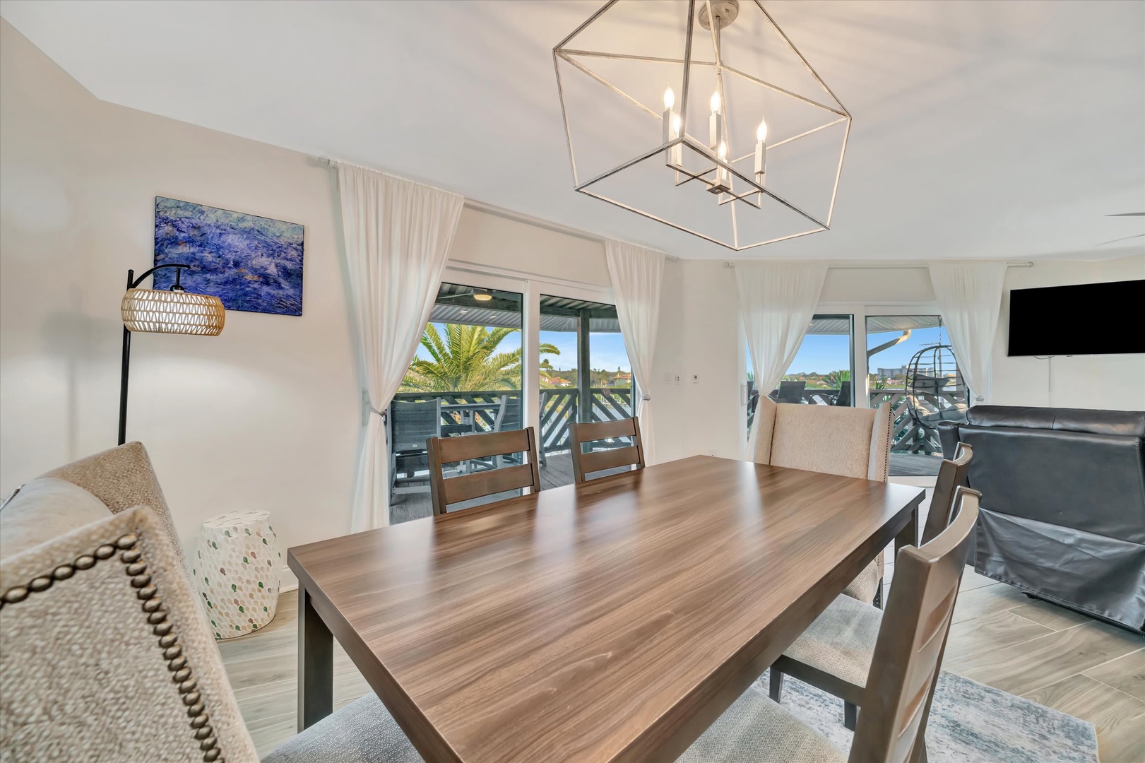 Gather around this spacious dining table bathed in natural light, where every meal becomes a moment to savor. Your private balcony awaits just beyond those elegant glass doors, inviting you to step outside and soak in the warmth.
