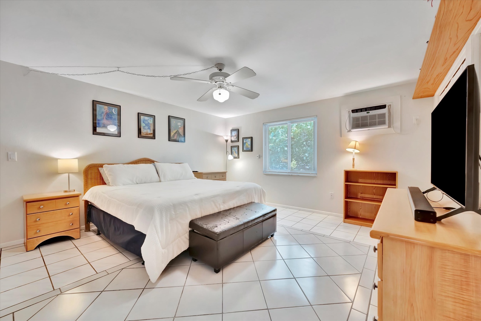 Sink into crisp linens and unwind in your bright, airy retreat with cool tile floors underfoot. Natural light streams in while the ceiling fan keeps things comfortable year-round.