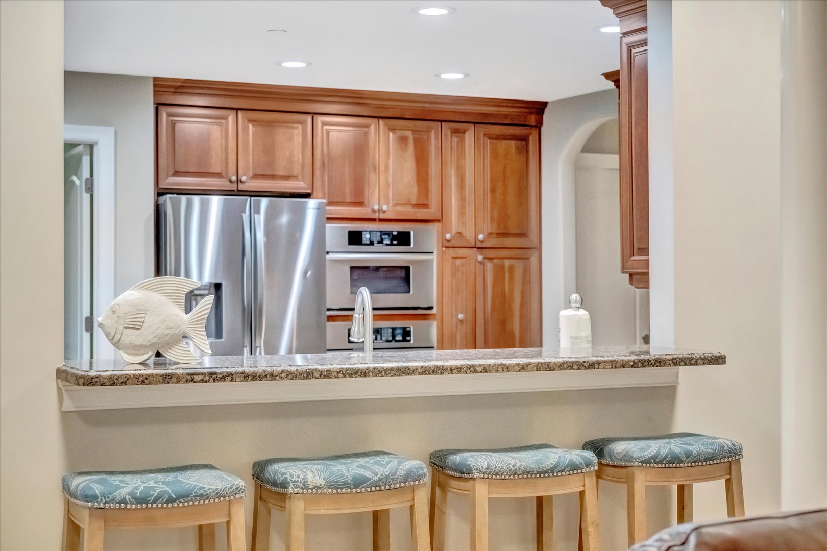 Prepare meals at your leisure in this fully equipped kitchen with granite counters, stainless appliances, and convenient bar seating—perfect for gathering over breakfast or evening appetizers.