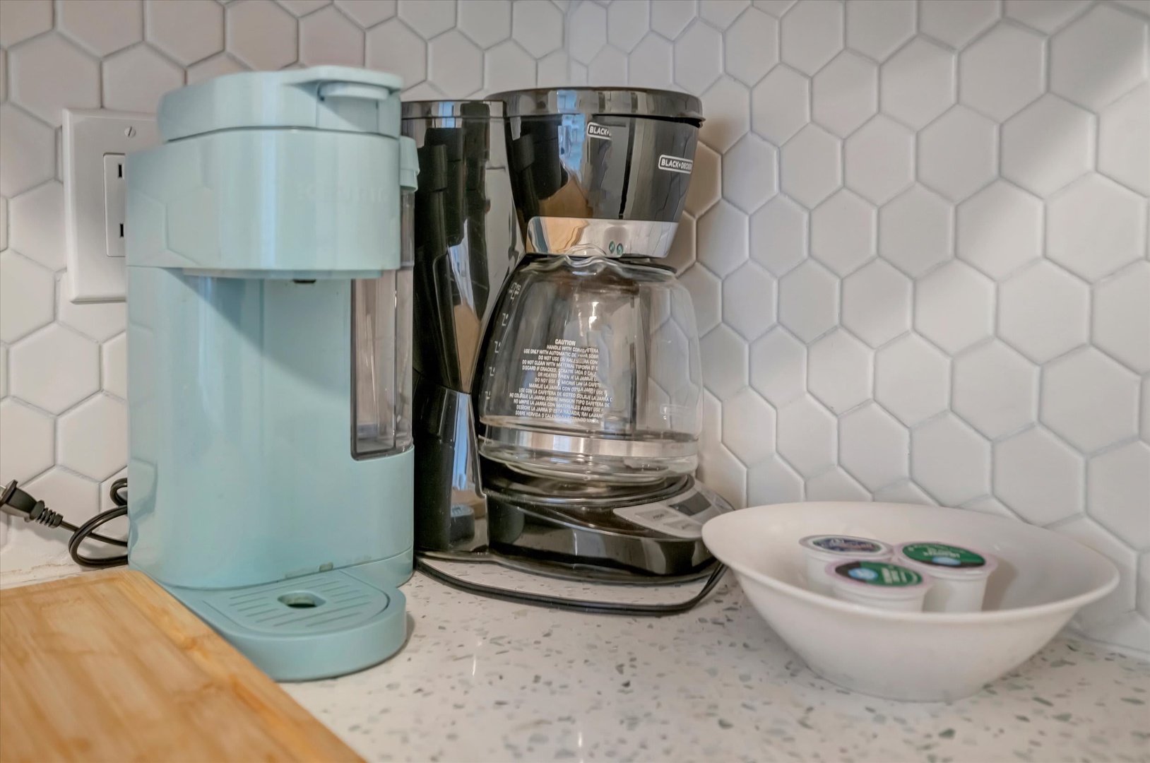 Start your morning right with a fresh cup of coffee from the in-room coffee maker. The stylish kitchen features modern countertops and a honeycomb tile backsplash, plus everything you need for a perfect brew.