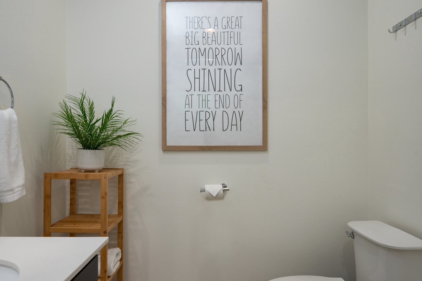 Bright, minimalist bathroom with an uplifting message to start your day. Clean lines and natural touches create a refreshing space for your morning routine.