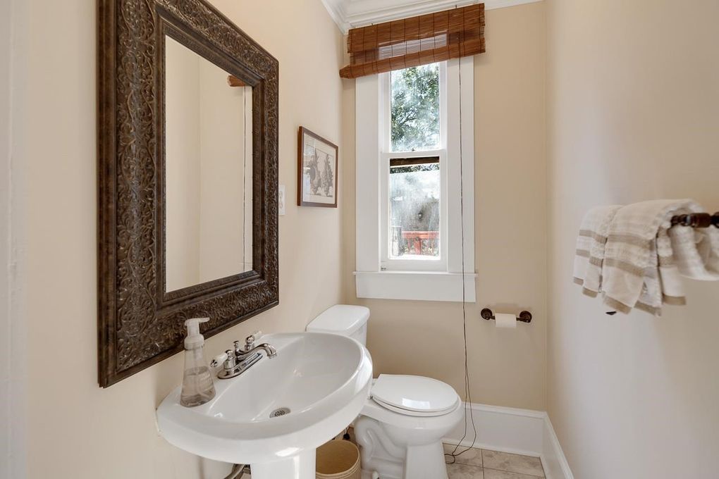 Bright and inviting, your bathroom features classic fixtures and thoughtful touches. Fresh towels await you, while natural light streams through the window, creating a warm and welcoming space for your daily routine.