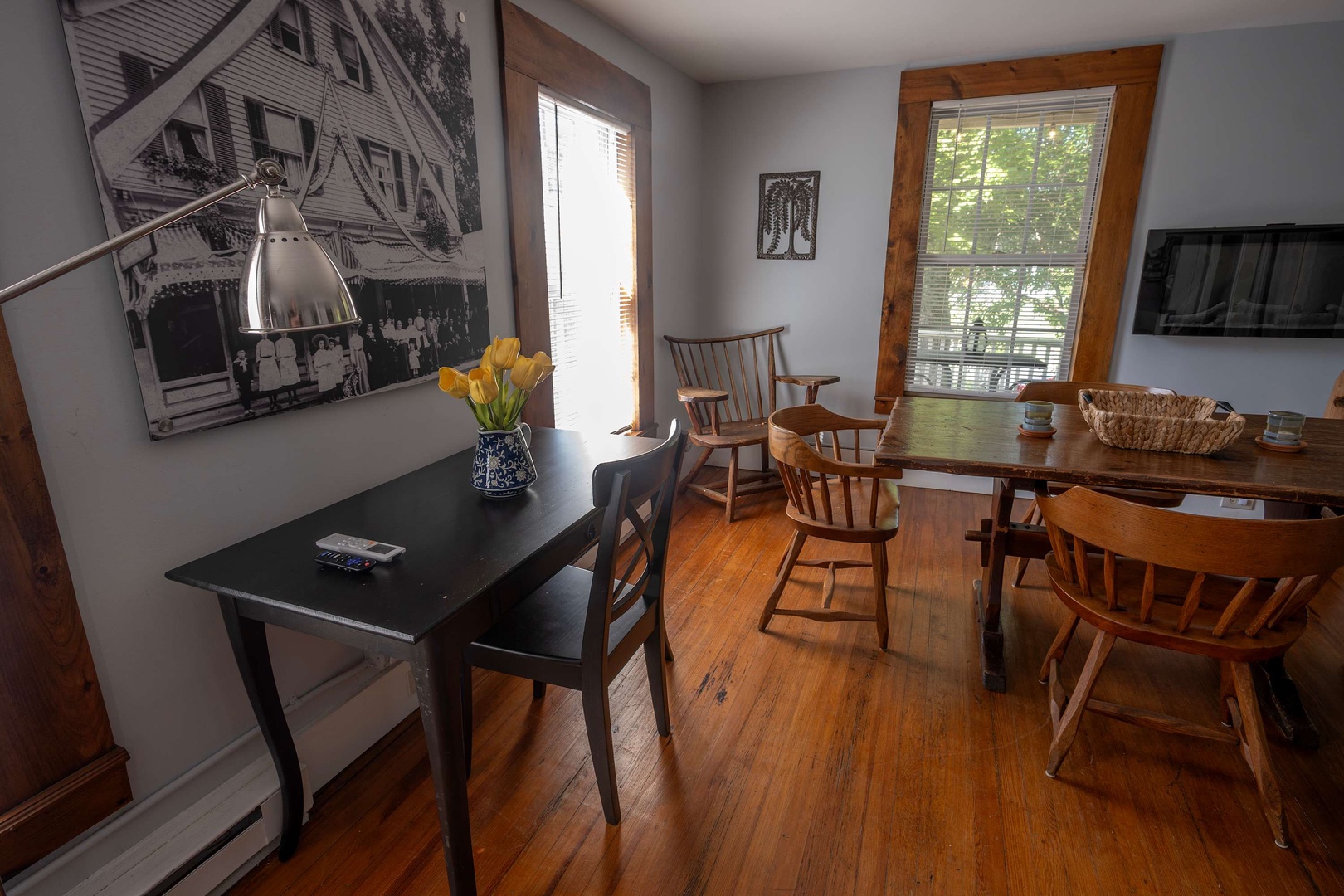 Gather around the handcrafted wooden dining table for meals bathed in natural light from charming windows overlooking lush greenery. Warm hardwood floors and cozy seating make every moment feel like home.