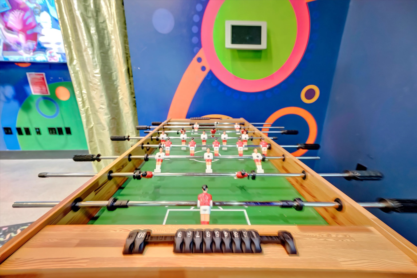 Challenge friends or family to a competitive match at the foosball table. Colorful wall art and a big-screen TV make this playful game room the perfect spot for fun and friendly competition.
