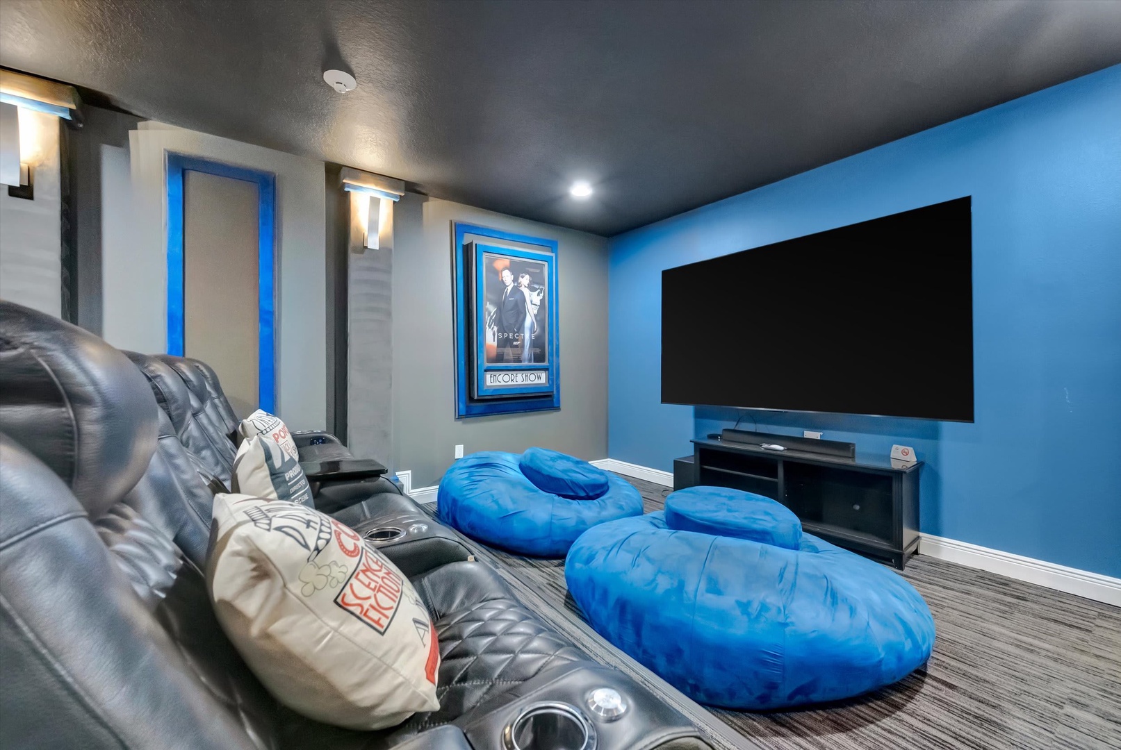 Settle into plush theater seating for an unforgettable movie night. Your private screening room awaits with bold blue accents, cinema-style décor, and a massive screen that transforms every evening into a cinematic escape.