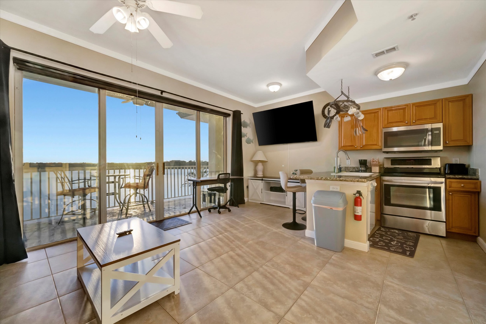 Bright and airy, your open-concept living space flows seamlessly to a private balcony overlooking serene water views. Relax with your morning coffee or unwind in the evening as the gentle breeze drifts in.