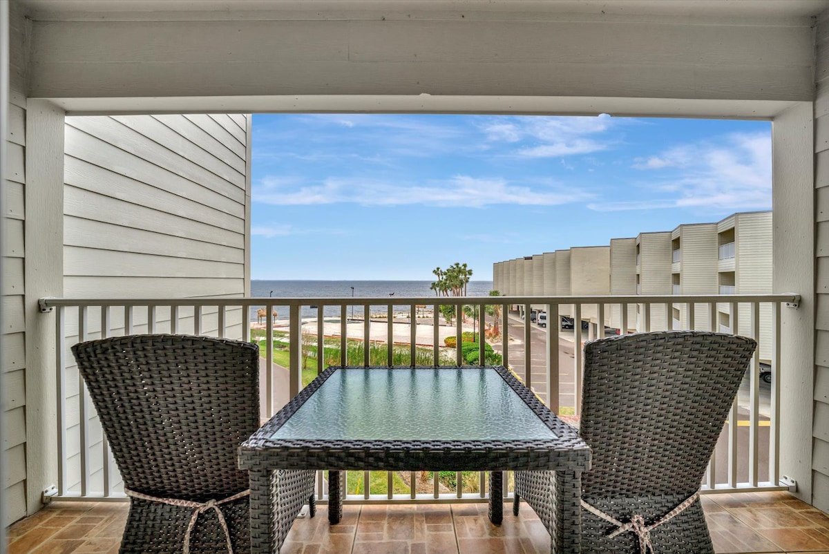 Settle into your private balcony with morning coffee and sweeping ocean views. The wicker seating invites you to unwind while breathing in the salt air and watching the waves roll in.