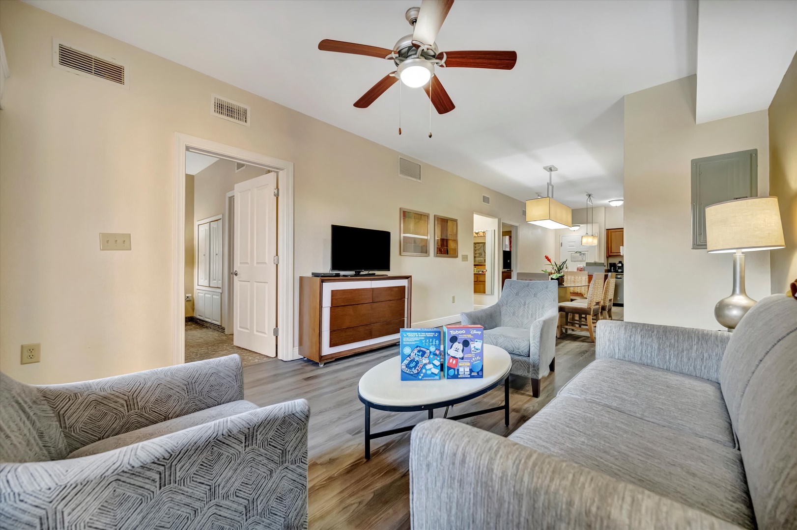 Unwind in your spacious living area with plush seating and soothing neutral tones. A ceiling fan keeps you comfortable while you relax or gather with loved ones.