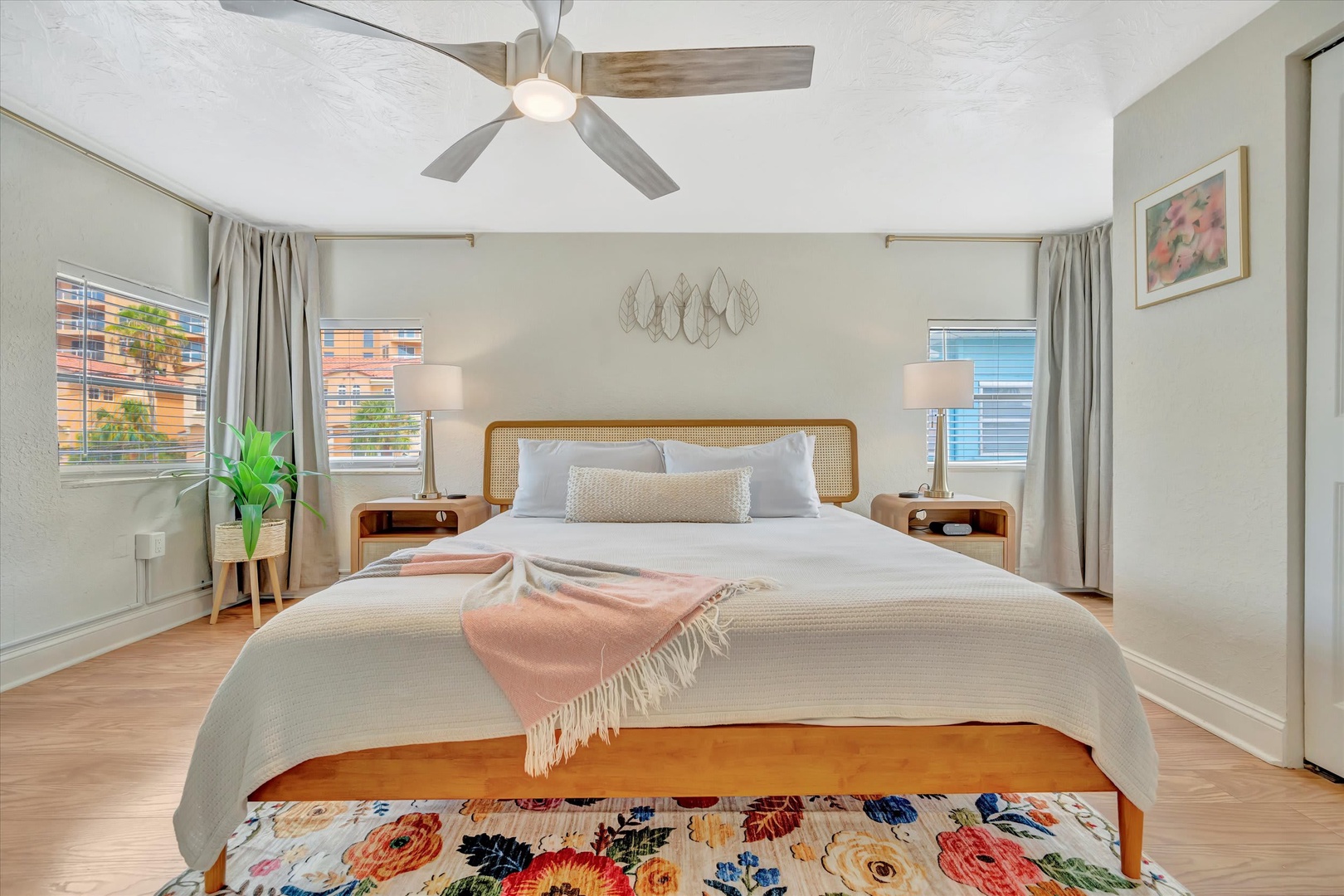 Your restful retreat awaits with a beautifully styled bed, calming natural light, and a ceiling fan keeping things cool and comfortable throughout your stay.