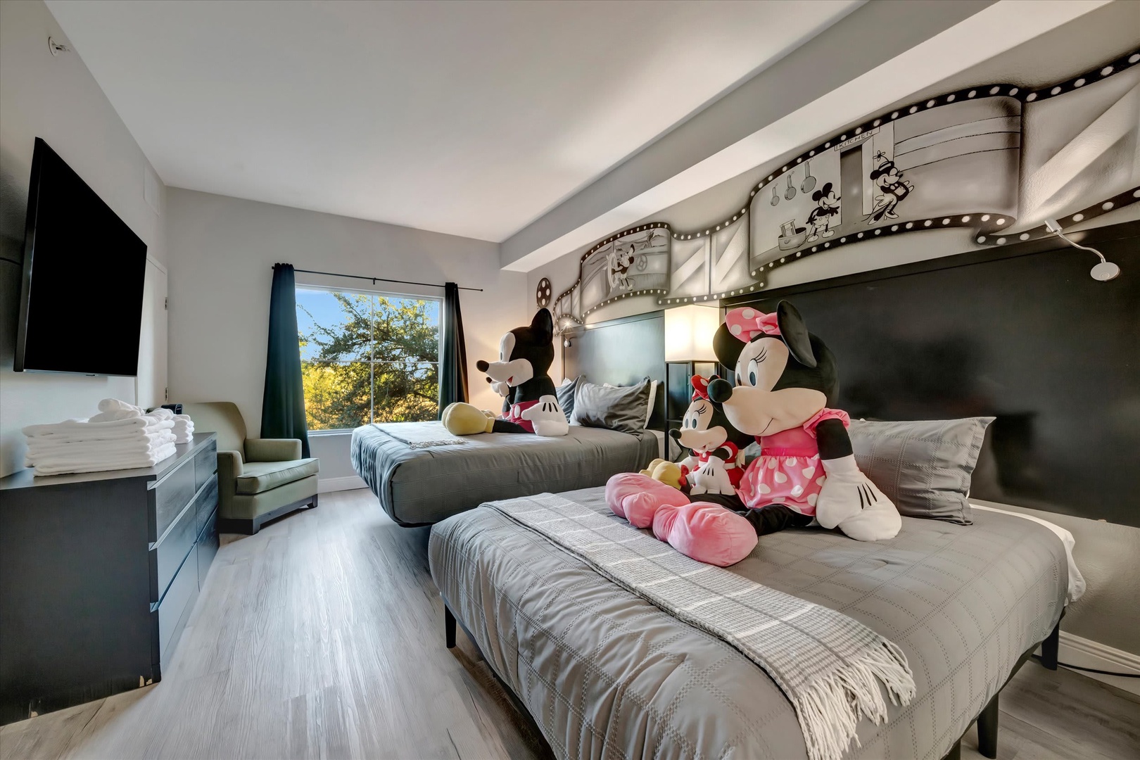 Your family will love this whimsical bedroom featuring two cozy beds, playful themed decor, and a sunny view—perfect for creating magical vacation memories together.