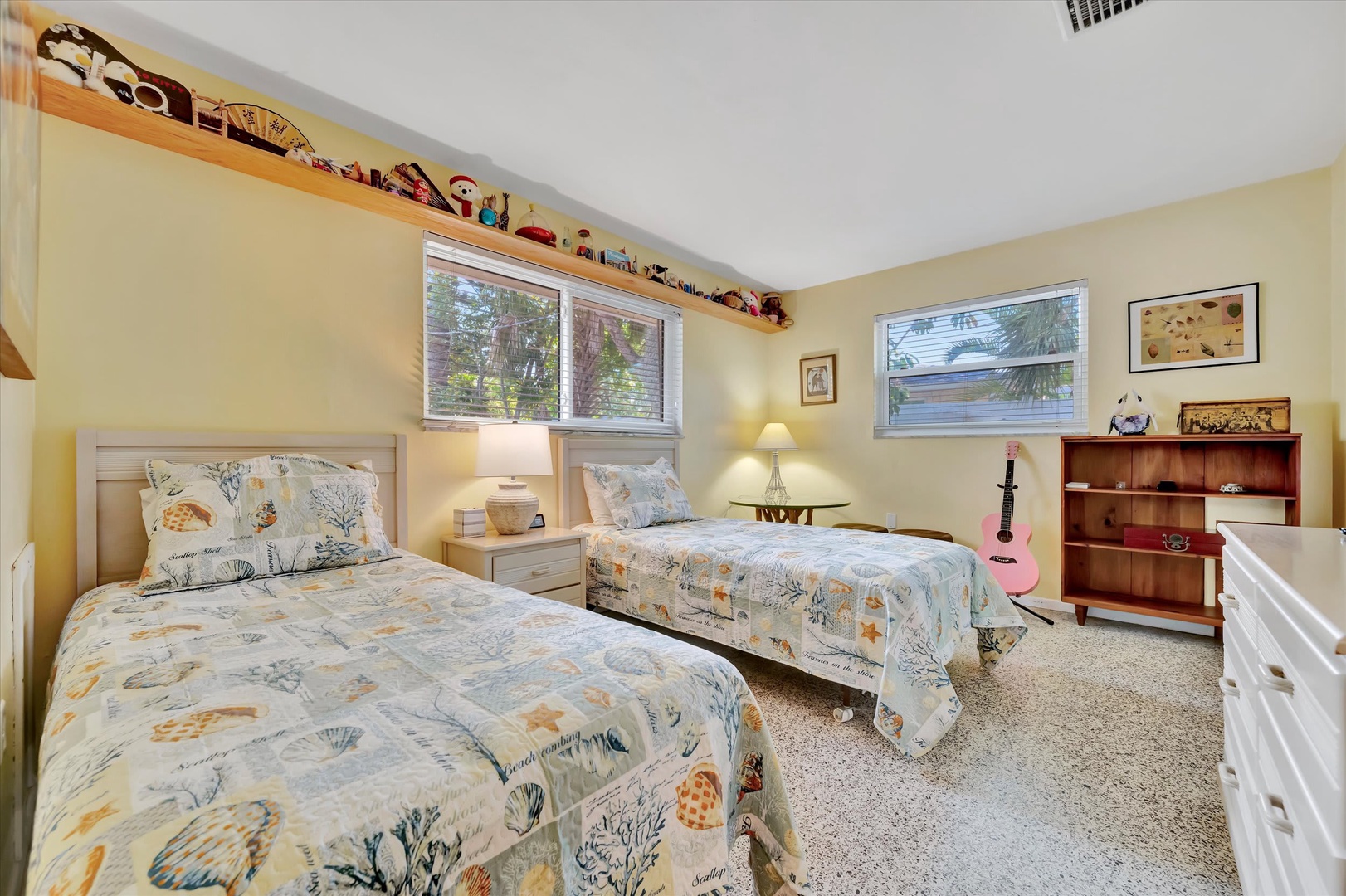 Settle into this cheerful twin bedroom where soft coastal linens and thoughtful details create a space that's all yours. Natural light pours in through generous windows while playful décor adds personality and charm.