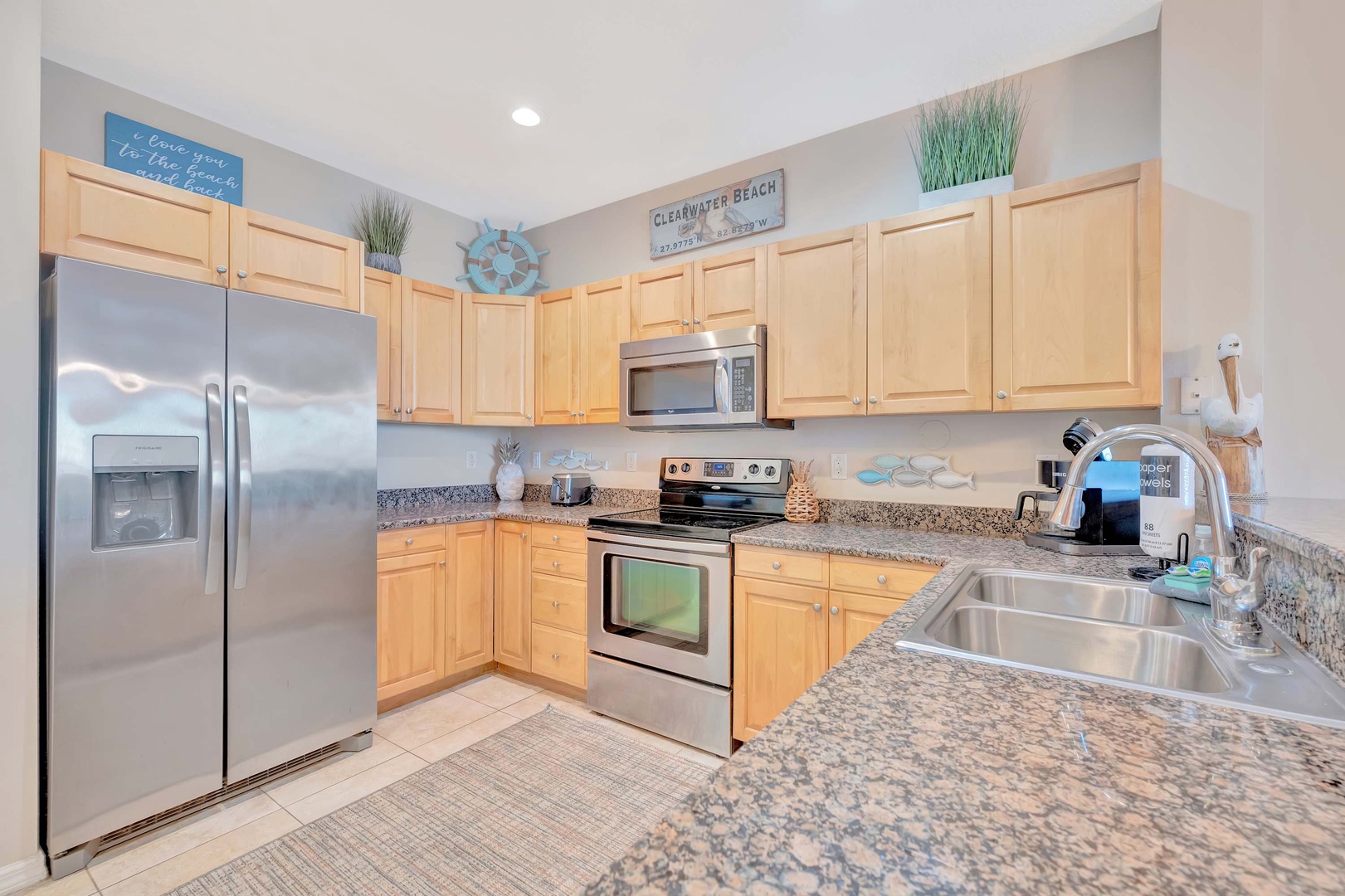 This bright, fully-equipped kitchen invites you to prepare your favorite meals with modern appliances and plenty of counter space. The coastal touches bring a relaxed, beachy vibe to your vacation stay.