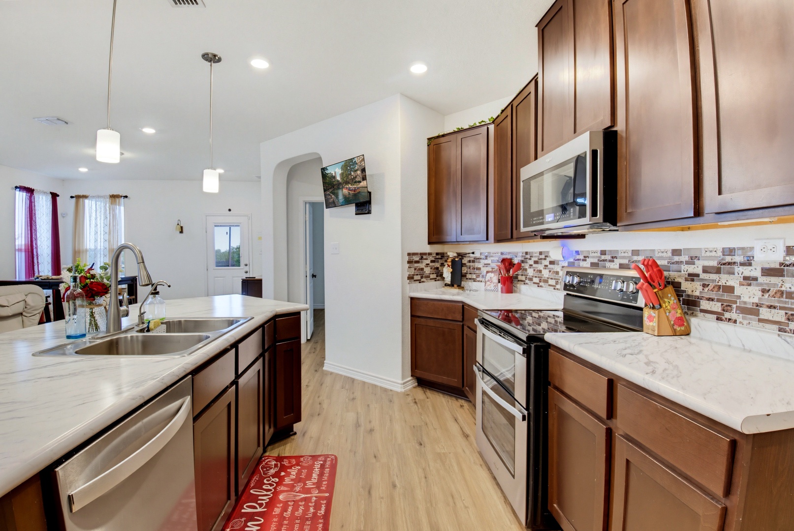 Cook your favorite meals in this bright, spacious kitchen with modern appliances, beautiful stone countertops, and plenty of prep space for your culinary adventures.