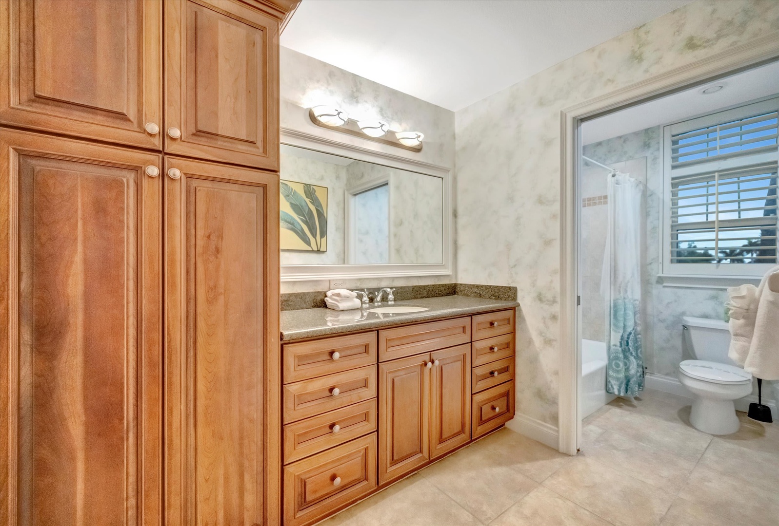 Your private bath features elegant cabinetry, granite countertops, and plenty of storage for all your essentials—a bright, serene space to start your day refreshed.