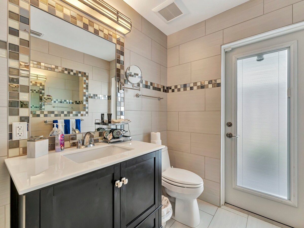 Freshen up in your stylishly tiled bathroom with modern fixtures and a warm color palette that invites relaxation.