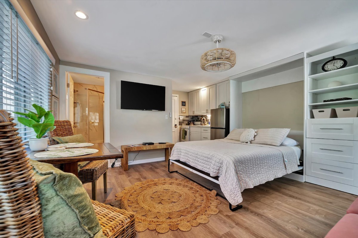 Unwind in your open and inviting studio, where natural light, warm wood tones, and thoughtful design create a relaxing retreat. Your space includes a full kitchen, comfortable sleeping area, and breezy ceiling fan for ultimate comfort.