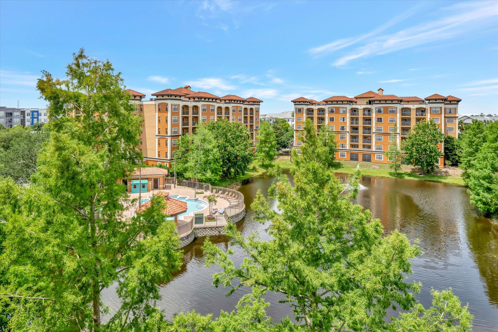 The property sits in a tranquil area surrounded by lush greenery and a peaceful lake, creating a scenic and serene arrival experience for guests.