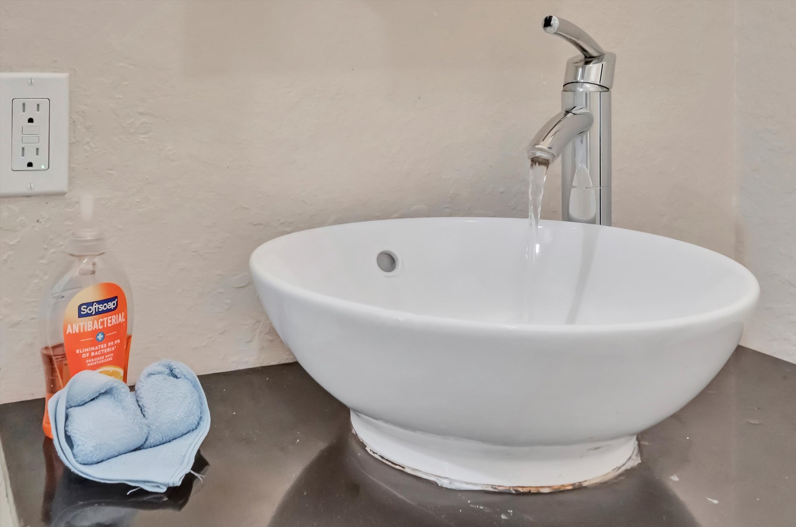 Step into your private bathroom and enjoy the sleek vessel sink with modern fixtures—your personal retreat awaits.