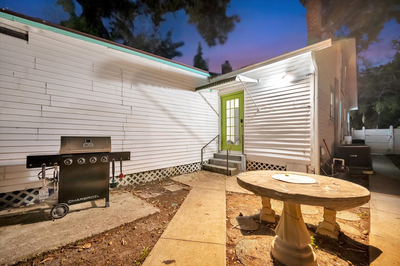 Your private backyard retreat features a gas grill ready for evening cookouts and a unique circular seating area where you can gather under the stars as twilight paints the sky.
