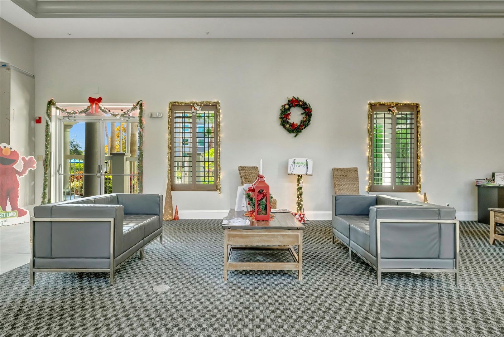 Bright, inviting lounge area adorned with festive holiday decor. Sunlight streams through plantation shutters, highlighting cozy seating perfect for relaxing between adventures.