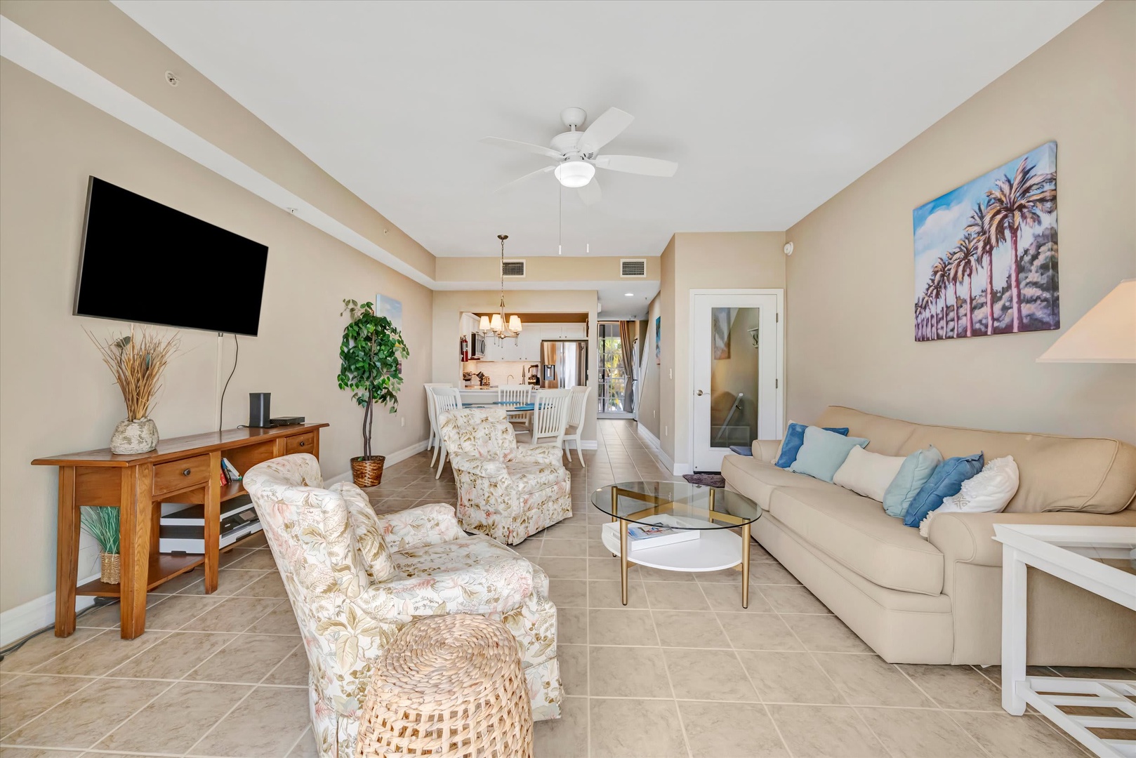 Relax in your bright, open living space with comfortable seating, a ceiling fan keeping you cool, and warm coastal touches throughout—your perfect home base for unwinding after a day of adventure.
