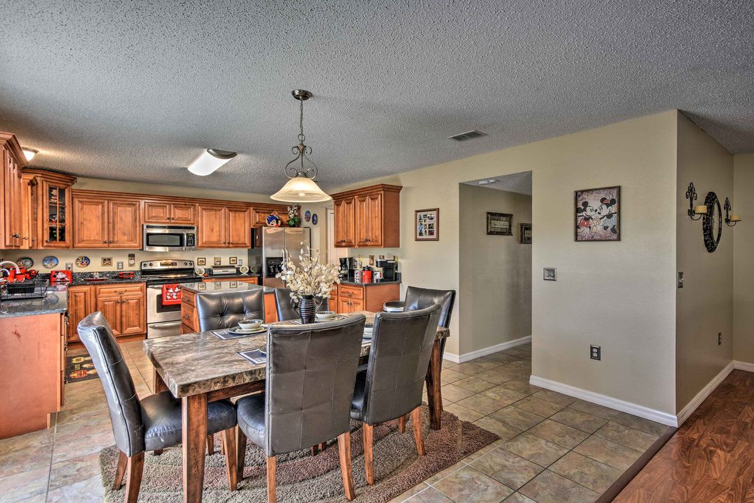 Gather around the spacious dining table and enjoy home-cooked meals in this well-appointed kitchen with beautiful wood cabinetry, modern appliances, and plenty of counter space for your culinary adventures.